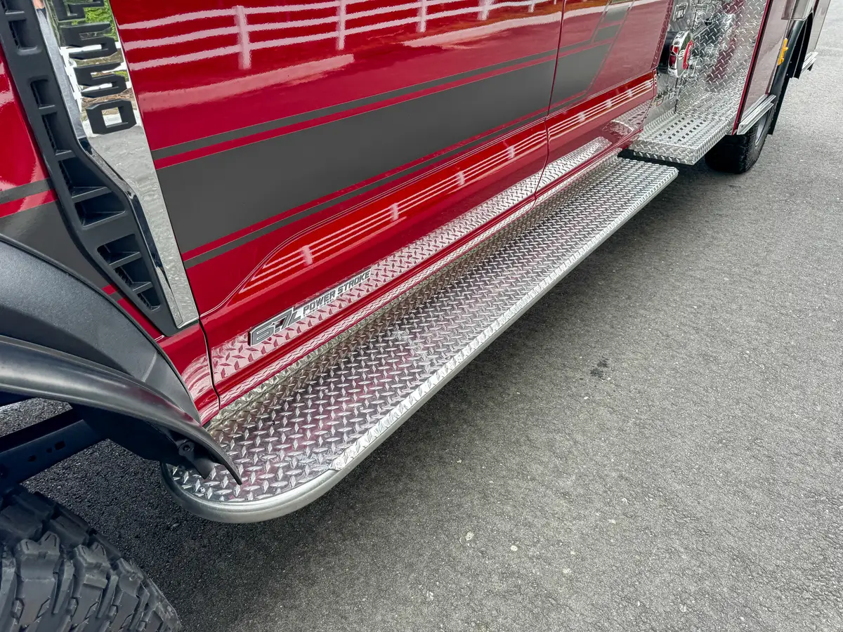 Lower side step and rocker-panel close-up with door-open edge visible.